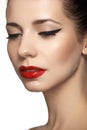 Cute model face with bright classical evening make-up, eyeliner on eyes, red lipstick