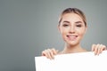 Cute model woman with clear skin holding empty white card singboard Royalty Free Stock Photo