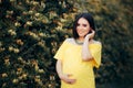 Portrait of a Beautiful Pregnant woman Wearing a Yellow Dress Royalty Free Stock Photo