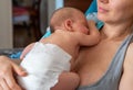 Cute 2 months little baby boy sleeping in his mothers arms Royalty Free Stock Photo