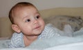 Cute 4 months old baby boy having tummy time and making funny faces Royalty Free Stock Photo