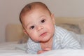 Cute 4 months old baby boy having tummy time and making funny faces Royalty Free Stock Photo