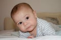 Cute 4 months old baby boy having tummy time and making funny faces Royalty Free Stock Photo