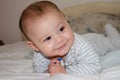 Cute 4 months old baby boy having tummy time and making funny faces Royalty Free Stock Photo