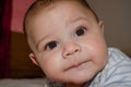 Cute 4 months old baby boy having tummy time and making funny faces Royalty Free Stock Photo