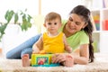 Cute mother and her child son play together indoor Royalty Free Stock Photo