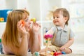 Cute mother and kid boy playing together indoor Royalty Free Stock Photo