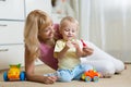 Cute mother and kid boy playing together indoors at home Royalty Free Stock Photo