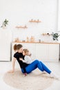 Cute mother kissing her little daughter and goes in for sports in the morning with in the kitchen. Healthy lifestyle Royalty Free Stock Photo