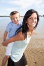 Cute mother and son boy having fun resting on the beach Royalty Free Stock Photo