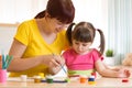 Cute mother teach her daughter kid to paint Royalty Free Stock Photo