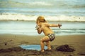 Cute muddy baby boy plays with wet sand Royalty Free Stock Photo