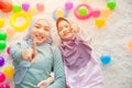 Cute Muslim Arab mother and her girl child happy playing together with colorful balls fun and lovely