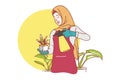 Cute muslim girl wearing hijab enjoying planting