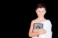 Cute Muslim Kid holding Quraan While Wearing Ihram During Hajj Royalty Free Stock Photo