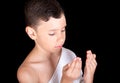 Cute Muslim Kid Praying While Wearing Ihram During Hajj Royalty Free Stock Photo