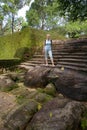 Cute natural barefoot blonde stands on the old steps