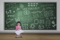 Cute nerd girl reading book in class Royalty Free Stock Photo