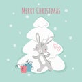 Cute New Year's rabbit near a white Christmas tree with gifts. Chinese character for 2023. Symbol of the year Royalty Free Stock Photo