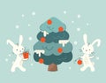 Cute New Year's rabbits decorate the Christmas tree. Bunny with a gift. Bunny with a Christmas ball. Chinese