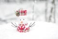 Cute new year snowman in a snow-covered fairy forest.