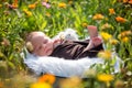 Cute newborn baby boy, sleeping peacefully in basket in garden Royalty Free Stock Photo