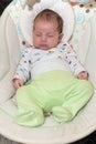 Cute newborn baby boy, sleeping in a swing Royalty Free Stock Photo