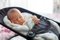 Cute newborn baby boy, sleeping in a swing Royalty Free Stock Photo