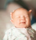 Cute newborn baby boy yawning in the arms of his mother. Royalty Free Stock Photo