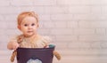 Cute newborn baby in creative decoration bucket bag. Infant girl sitting inside bowl. Pinky colours Royalty Free Stock Photo