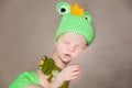 Cute newborn baby in a frog costume Royalty Free Stock Photo