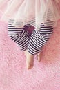 Cute Newborn Baby Girl Feet on Pink Blanket