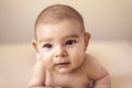 Cute newborn baby girl lying on simple beige background