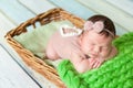 Cute newborn baby girl in a pink knit romper Royalty Free Stock Photo