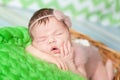 Cute newborn baby girl in a pink knit romper Royalty Free Stock Photo