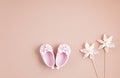 Cute newborn baby girl shoes with festive decoration over pink background. Baby shower, birthday, invitation or greeting card Royalty Free Stock Photo