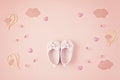 Cute newborn baby girl shoes with festive decoration over pink background. Baby shower, birthday, invitation or greeting card Royalty Free Stock Photo