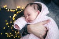 A cute newborn baby girl sleeps in her mother's arms. Royalty Free Stock Photo