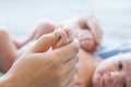 Cute newborn baby hold mother by the thumb