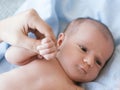 Cute newborn baby hold mother by the thumb