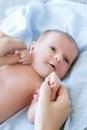 Cute newborn baby hold mother by the thumbs