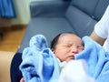 Cute newborn baby sleeping in hands of parents. Royalty Free Stock Photo