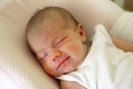 Cute newborn baby is sleeping with smile on her face Royalty Free Stock Photo