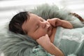 Cute newborn baby sleeping in wicker basket, closeup Royalty Free Stock Photo