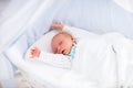 Cute newborn baby in white bed Royalty Free Stock Photo