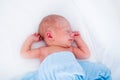 Cute newborn baby in white bed Royalty Free Stock Photo