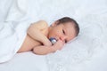 Cute newborn boy girl with baby's dummy on background of white l Royalty Free Stock Photo