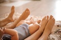 Cute newborn foot with parents