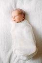 Cute newborn girl sleeping on furry cloth wearing white headband Royalty Free Stock Photo