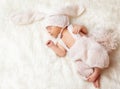 Cute Newborn sleeping on Blanket. New Born Baby in Rabbit Hat with Ears. Infant wearing knitted Bunny Costume. Child Birth Royalty Free Stock Photo